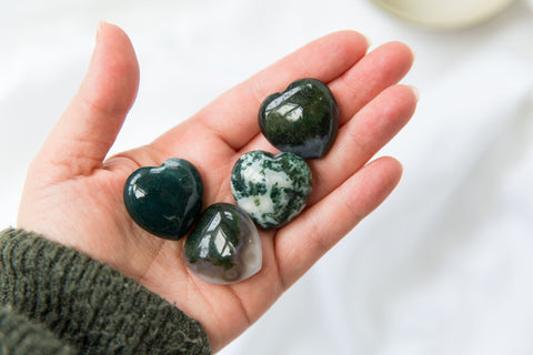 Hand holding Moss Agate Crystal Hearts